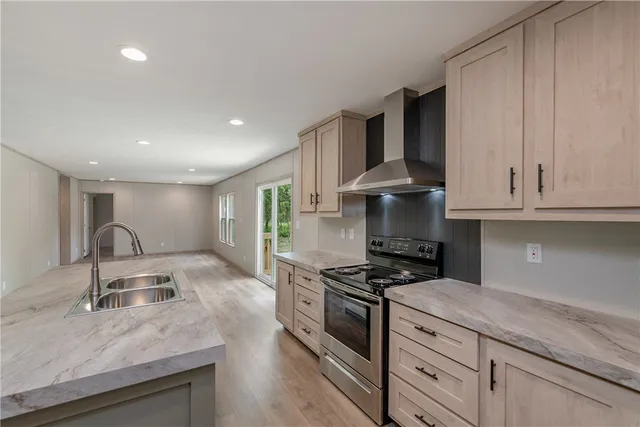 a kitchen with granite countertop a sink stainless steel appliances and cabinets