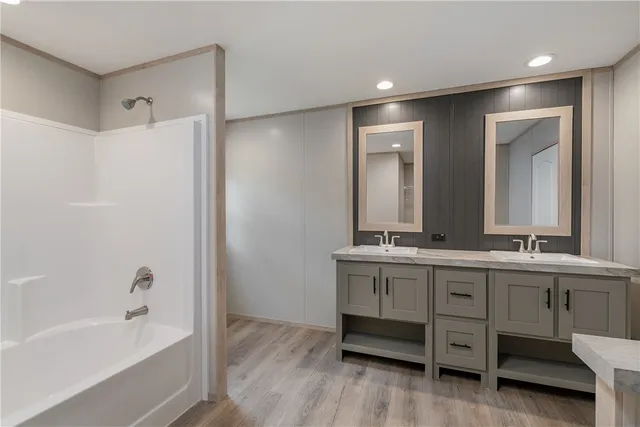 a bathroom with a double vanity sink and a bathtub