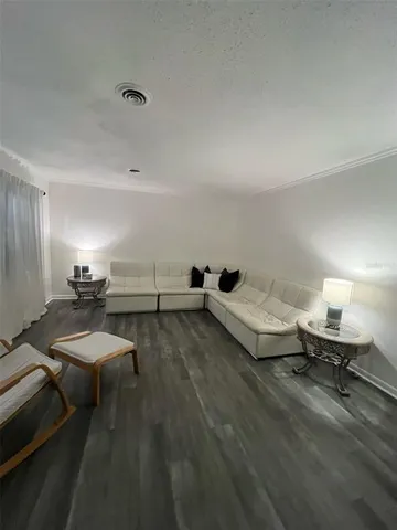 a view of wooden floor and window in an empty room