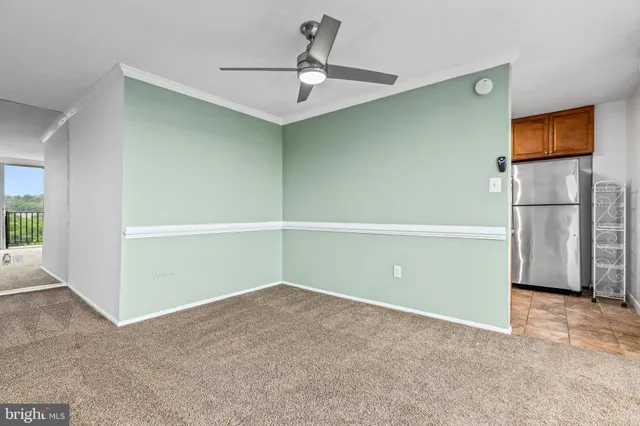 a view of a room with a ceiling fan