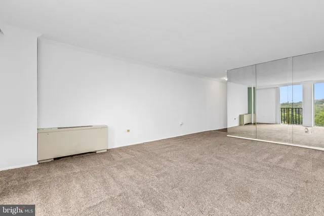 a view of an empty room with a fireplace