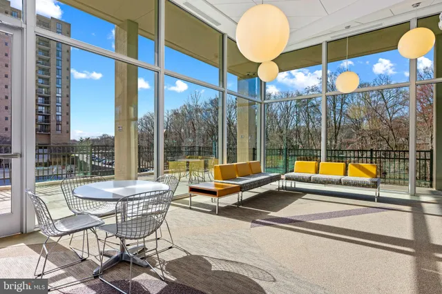 a view of swimming pool with seating area and furniture