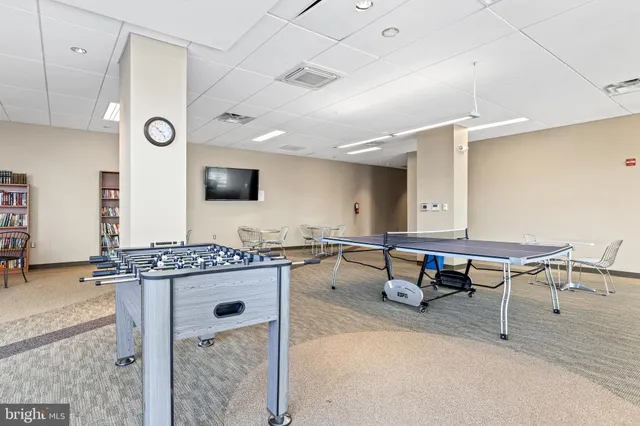 a reading room with furniture pool table and flat screen tv