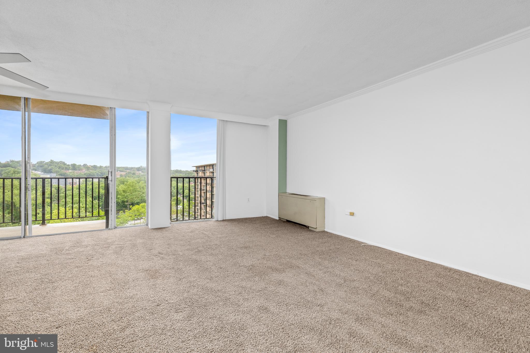 4600 South Four Mile Run Drive, Unit 1142 Arlington, VA 22204 - Photo 4 of 34 a view of an empty room with a balcony