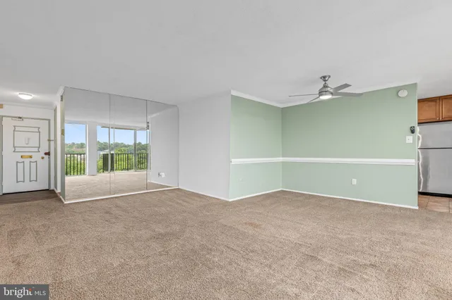 an empty room with a fireplace and large window