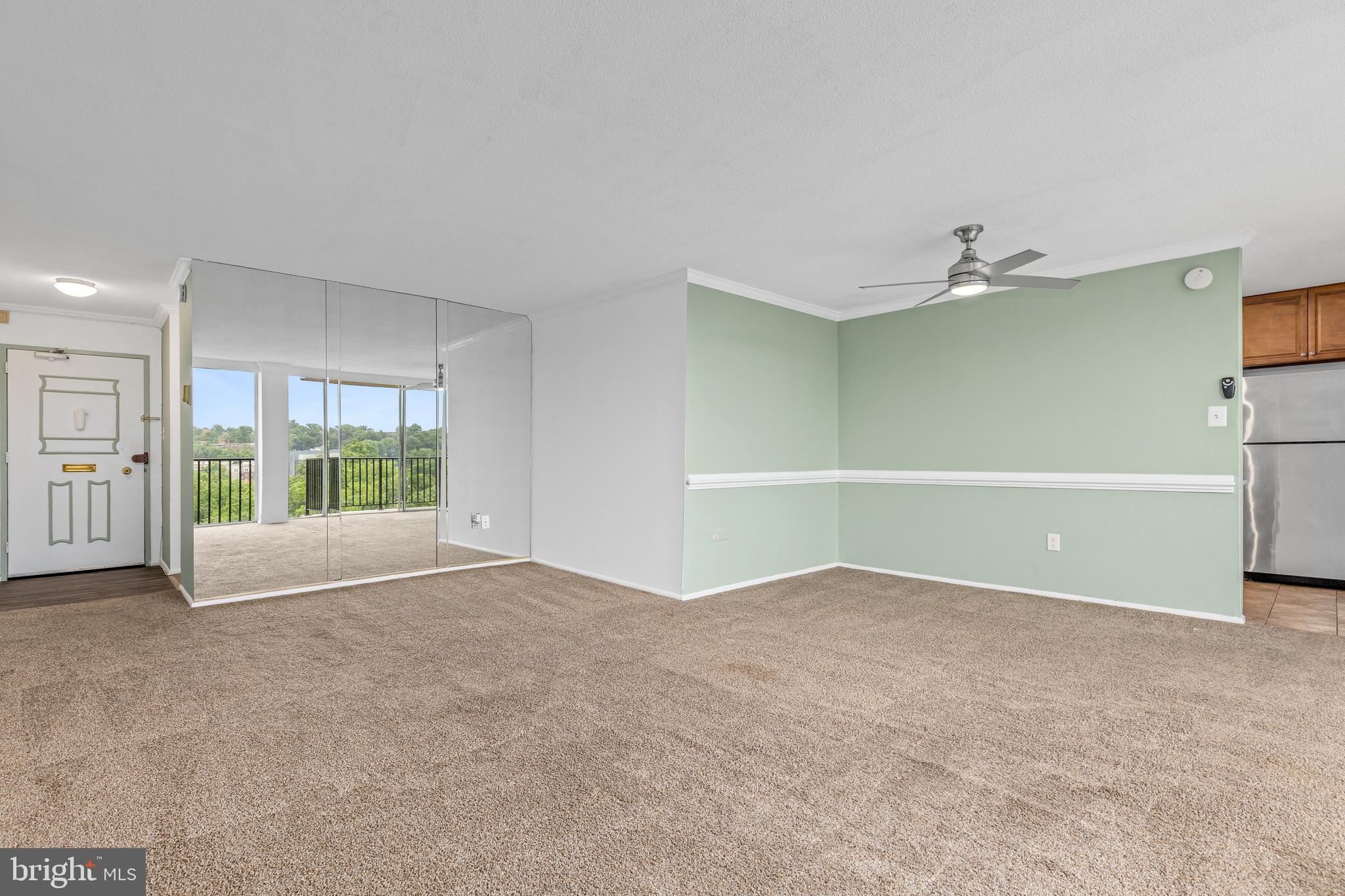 4600 South Four Mile Run Drive, Unit 1142 Arlington, VA 22204 - Photo 9 of 34 an empty room with a fireplace and large window