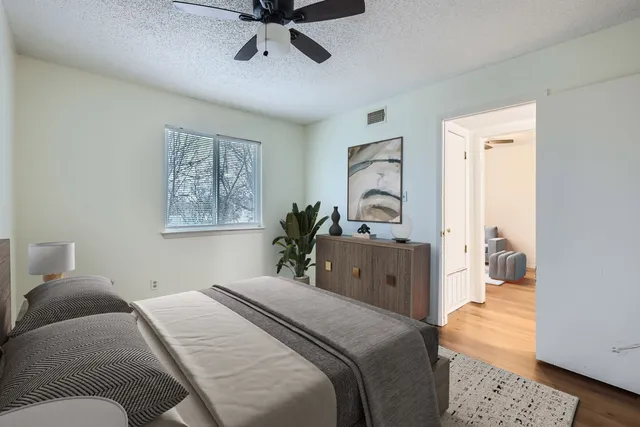 a bedroom with a large bed and a chandelier