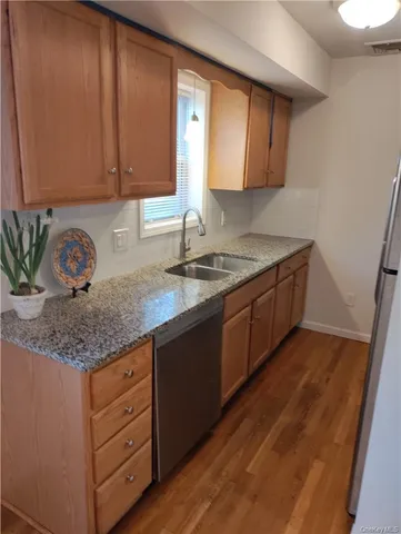 a view of a kitchen with wooden floor