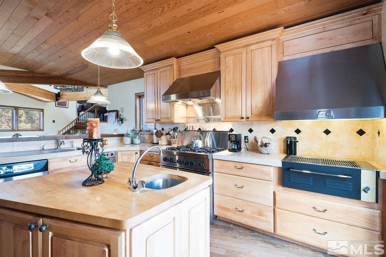 2570 Musket Road Reno, NV 89521 - Photo 5 of 25 a kitchen with cabinets and white appliances