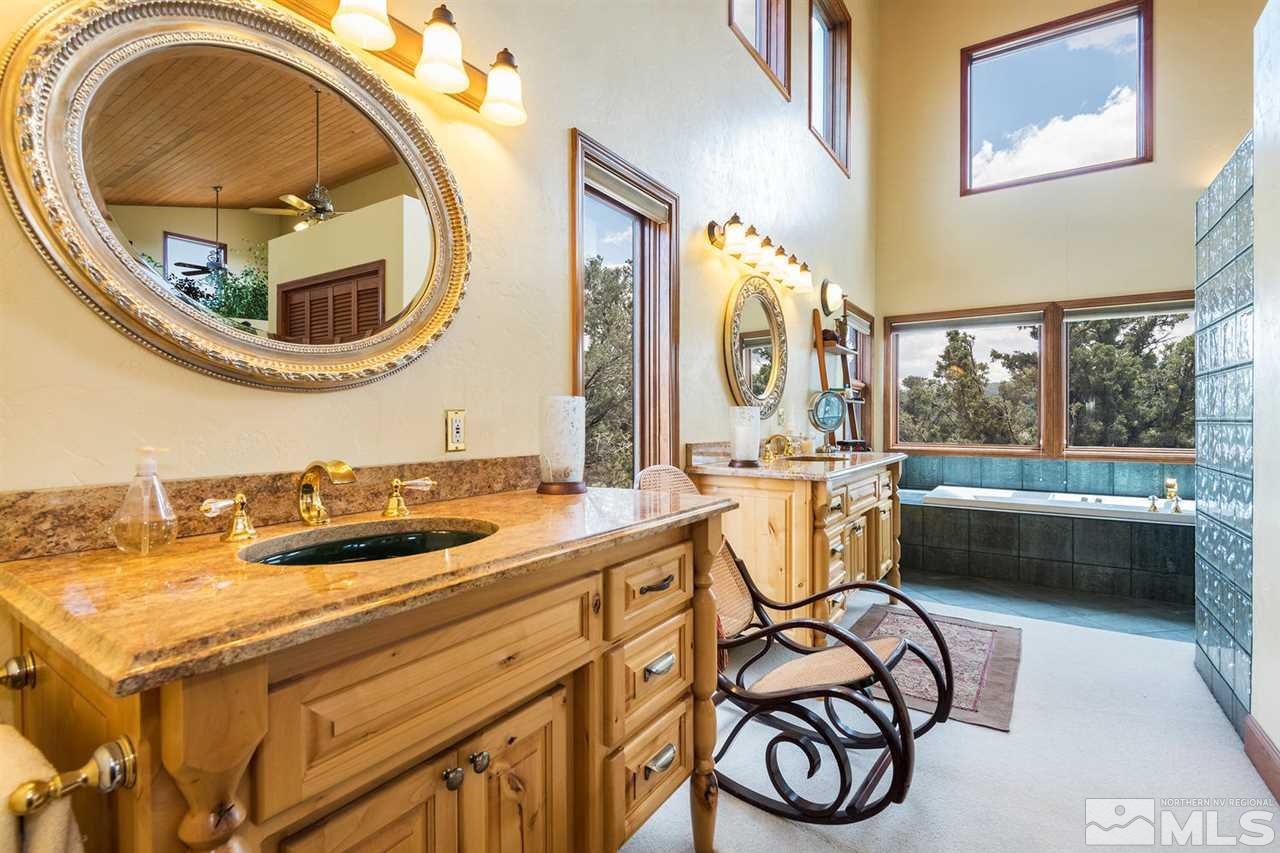 2570 Musket Road Reno, NV 89521 - Photo 8 of 25 a bathroom with a granite countertop tub and a mirror