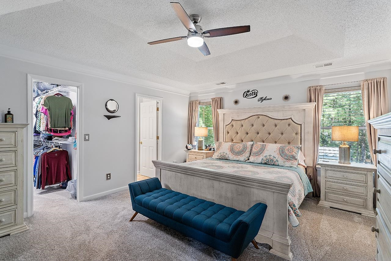 6 Esterbrook Court Durham, NC 27703 - Photo 16 of 31 a bedroom with a bed and a walk in closet