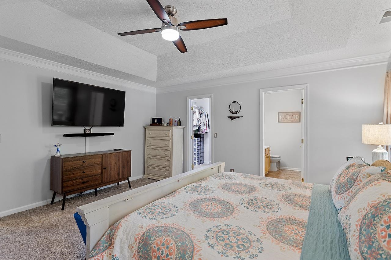 6 Esterbrook Court Durham, NC 27703 - Photo 17 of 31 a bedroom with bed and tv with wooden floor