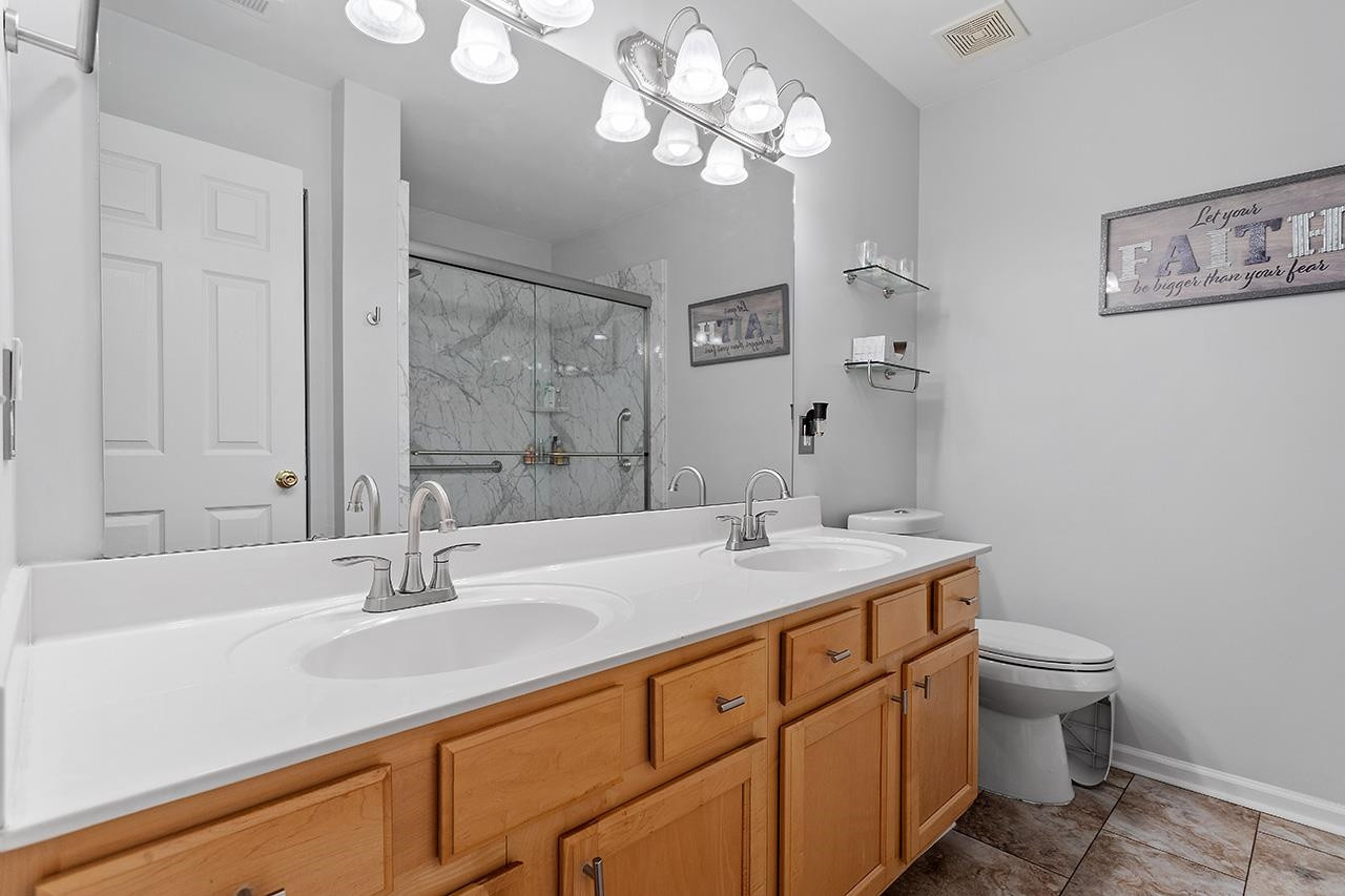 6 Esterbrook Court Durham, NC 27703 - Photo 18 of 31 a bathroom with a sink a toilet and large mirror