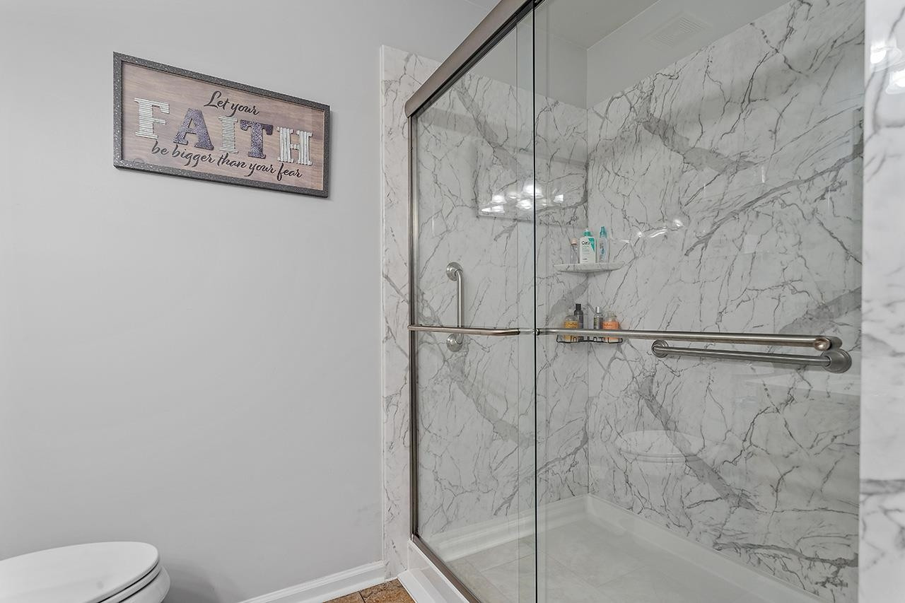 6 Esterbrook Court Durham, NC 27703 - Photo 19 of 31 a bathroom with a shower and toilet
