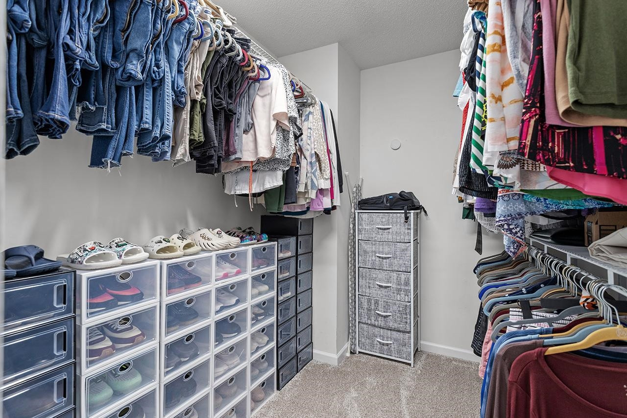 6 Esterbrook Court Durham, NC 27703 - Photo 20 of 31 a view of walk in closet with clothes and shoes
