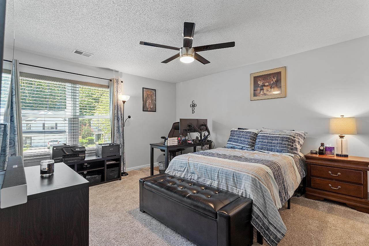 6 Esterbrook Court Durham, NC 27703 - Photo 21 of 31 a bedroom with a bed and wooden floor