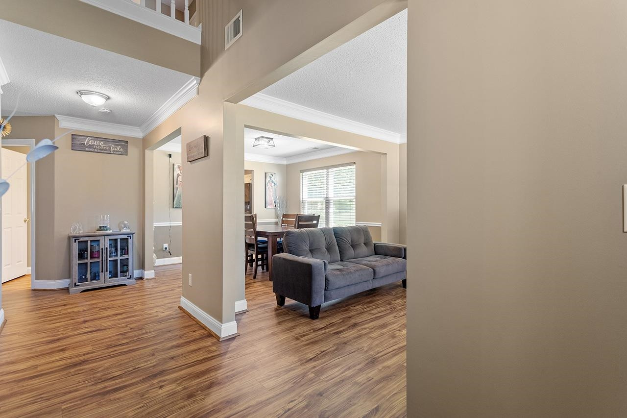 6 Esterbrook Court Durham, NC 27703 - Photo 4 of 31 a living room with furniture and a wooden floor