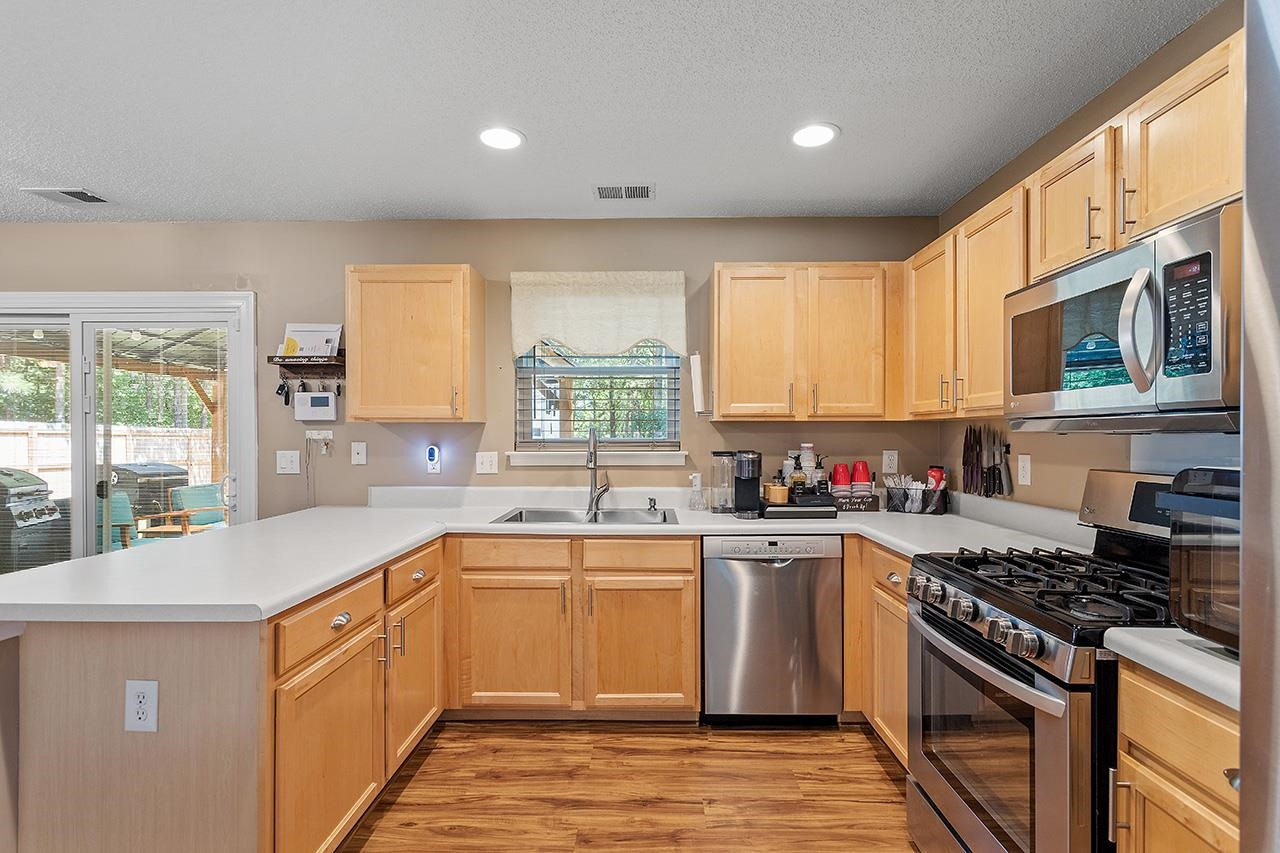 6 Esterbrook Court Durham, NC 27703 - Photo 7 of 31 a kitchen with a sink stove top oven and refrigerator