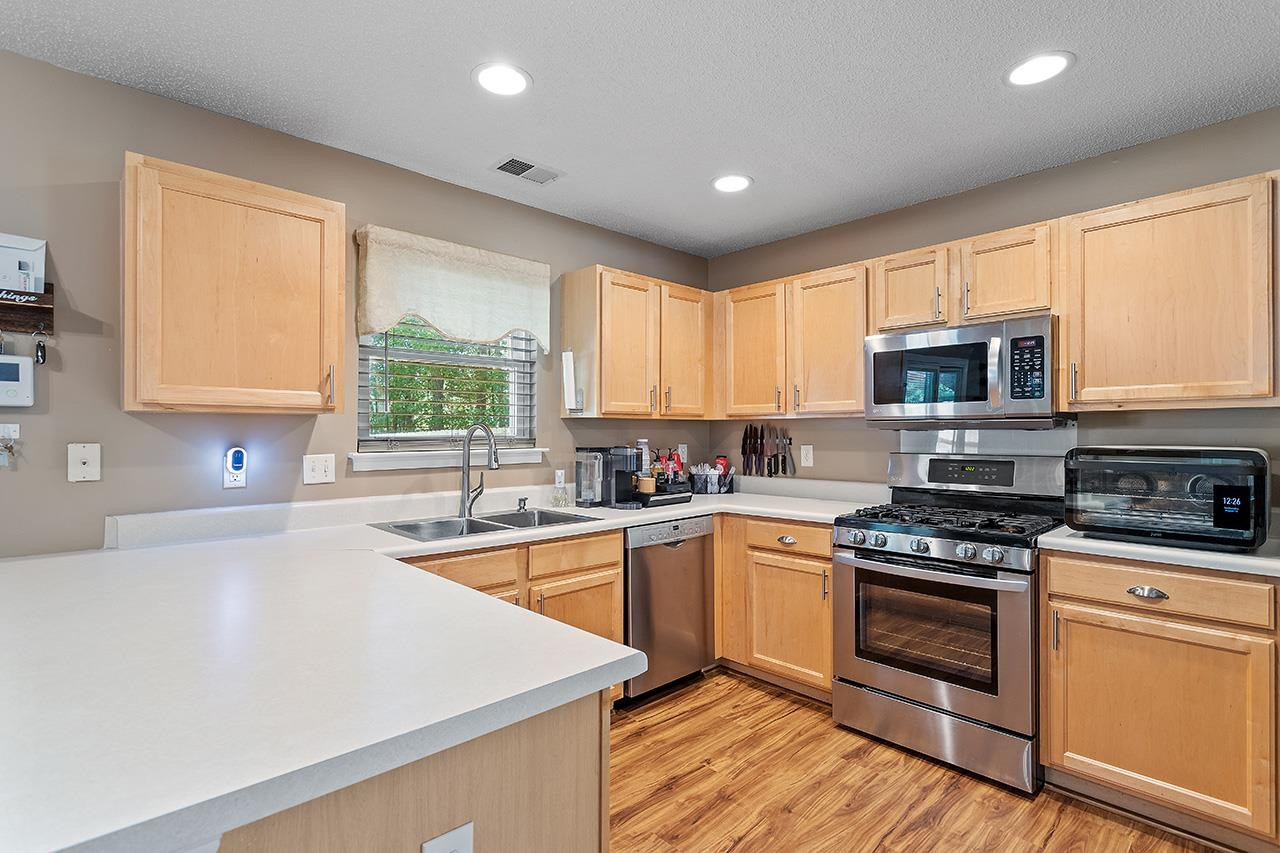 6 Esterbrook Court Durham, NC 27703 - Photo 8 of 31 a kitchen with granite countertop a stove top oven sink and cabinets