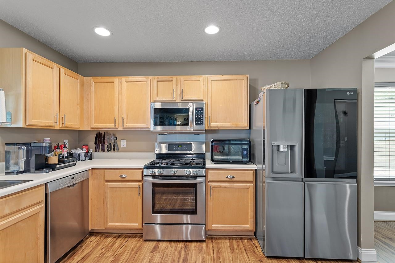 6 Esterbrook Court Durham, NC 27703 - Photo 9 of 31 a kitchen with a refrigerator stove and microwave