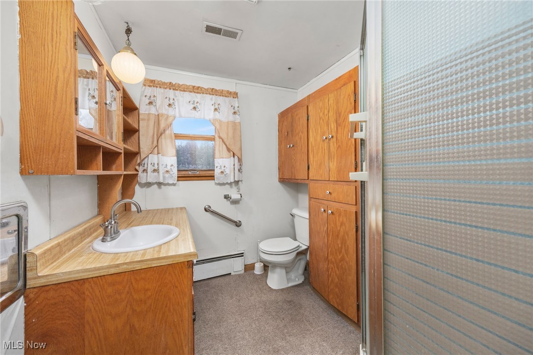 9952 Sterling Road Rittman, OH 44270 - Photo 16 of 28 Bathroom featuring vanity and a baseboard radiator