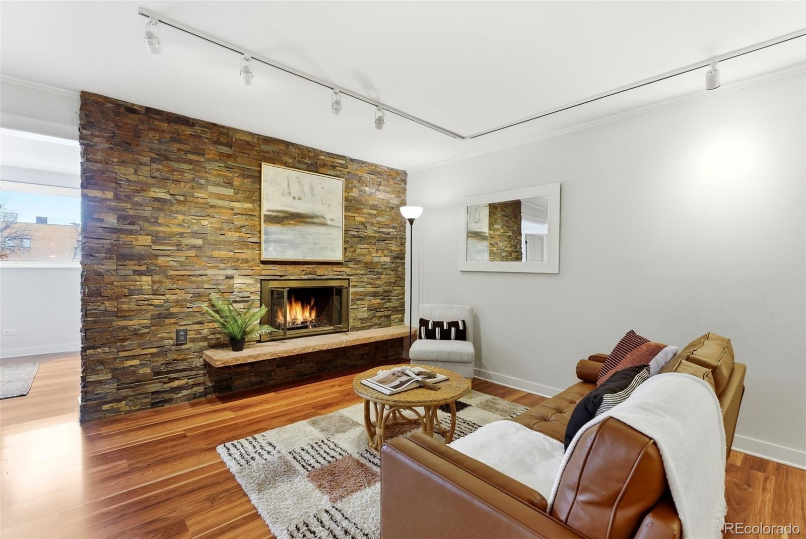 2 Adams Street, Unit 105 Denver, CO 80206 - Photo 11 of 50 a living room with furniture and a fireplace