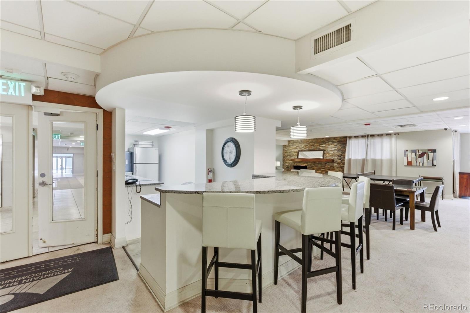 2 Adams Street, Unit 105 Denver, CO 80206 - Photo 22 of 50 a kitchen with a table and chairs in it