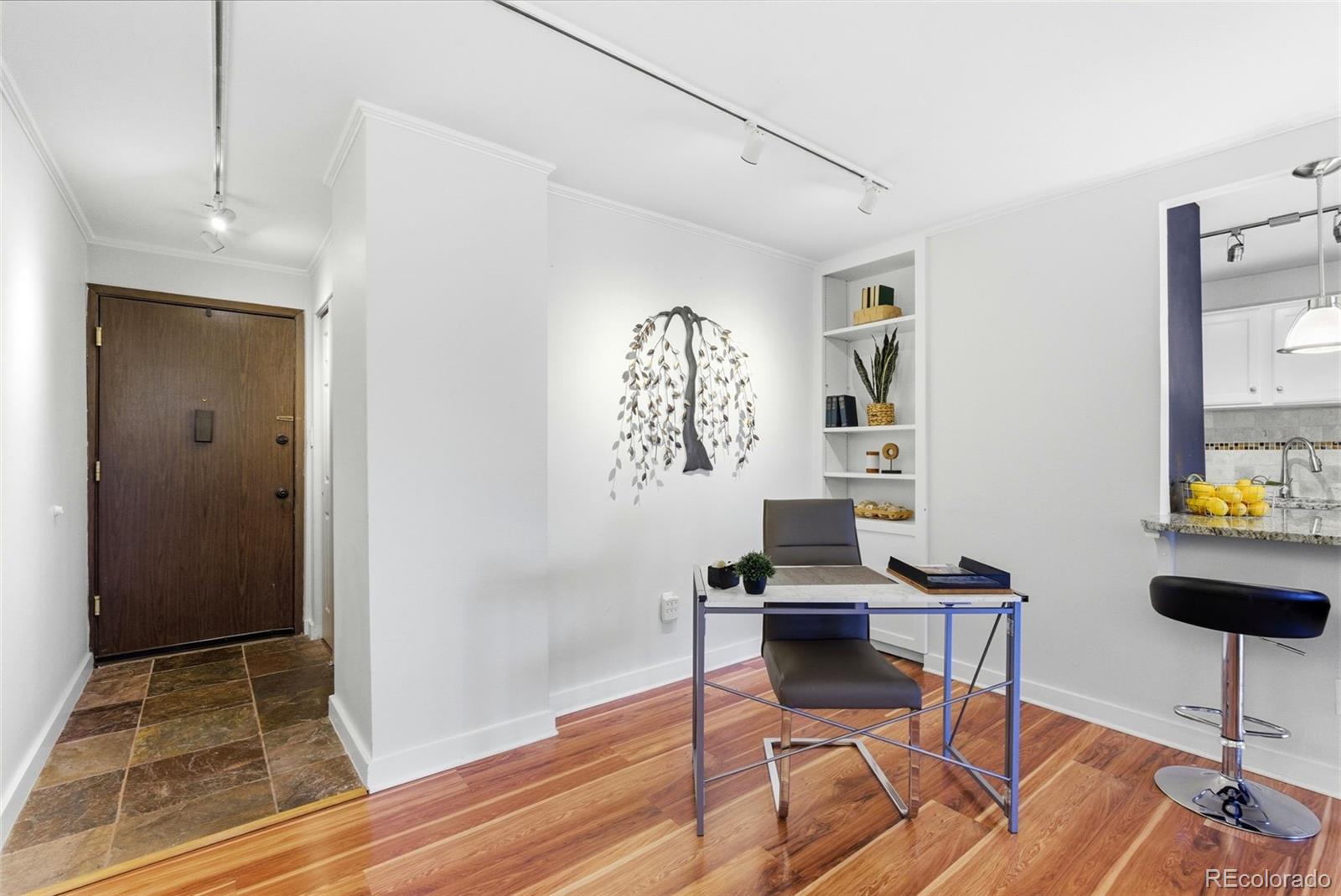 2 Adams Street, Unit 105 Denver, CO 80206 - Photo 4 of 50 a view of a workspace with furniture and wooden floor