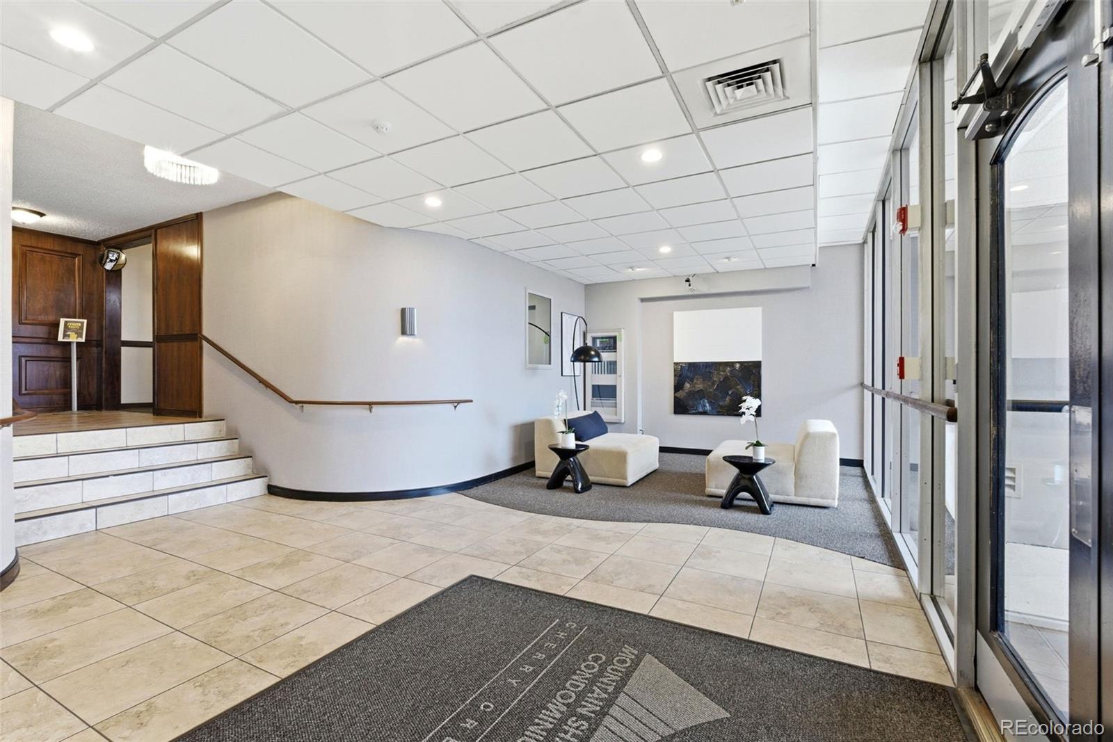 2 Adams Street, Unit 105 Denver, CO 80206 - Photo 49 of 50 a view of a hallway with a couch and a fireplace
