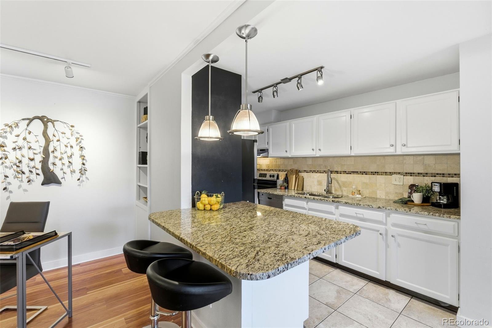 2 Adams Street, Unit 105 Denver, CO 80206 - Photo 5 of 50 a kitchen with a sink cabinets and window