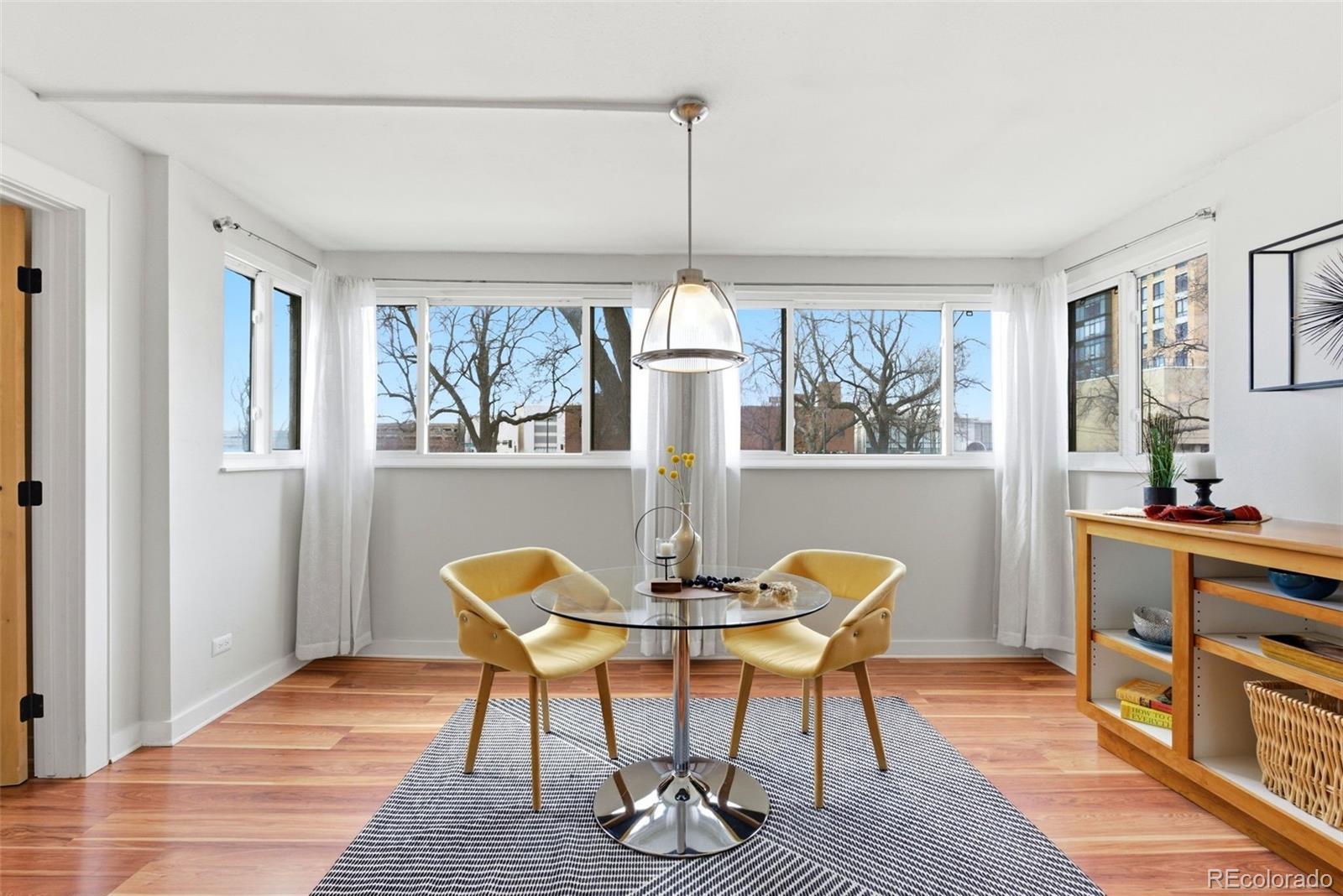 2 Adams Street, Unit 105 Denver, CO 80206 - Photo 6 of 50 a view of a dining room with furniture window and wooden floor