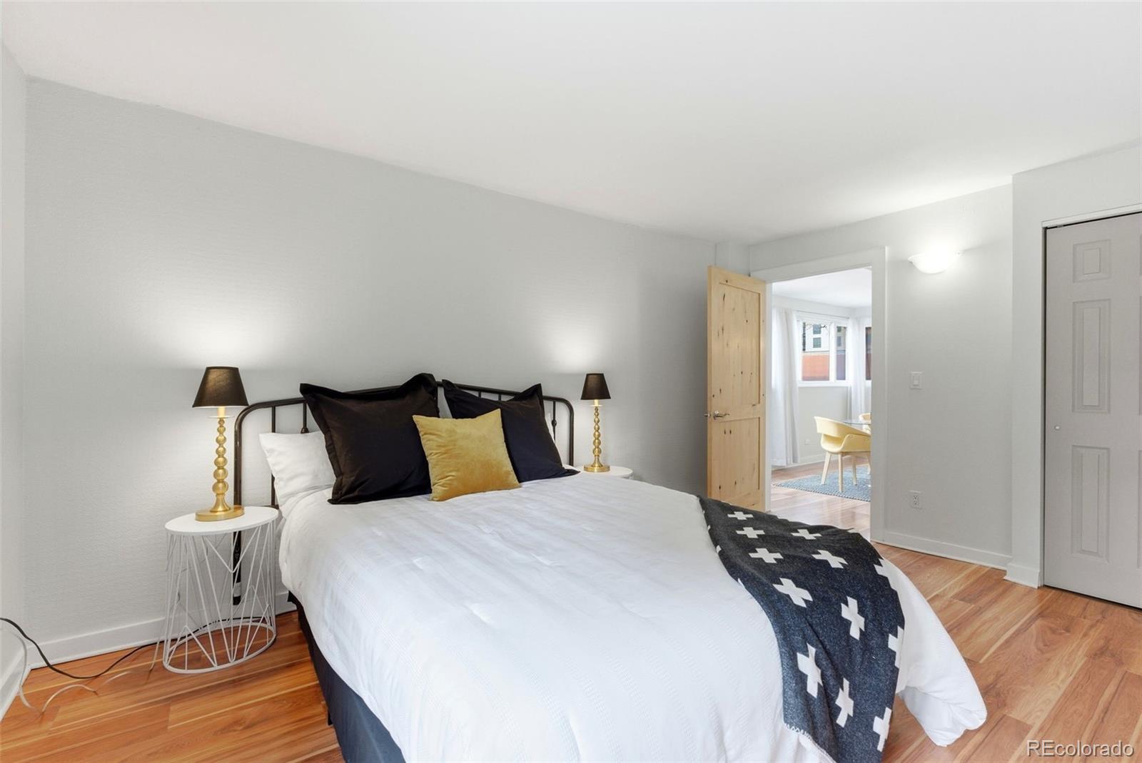 2 Adams Street, Unit 105 Denver, CO 80206 - Photo 10 of 50 a bedroom with a bed and wooden floor