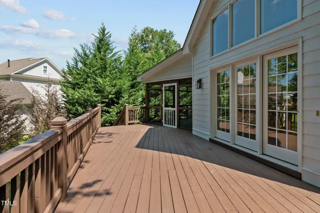 a view of balcony with wooden floor and fence