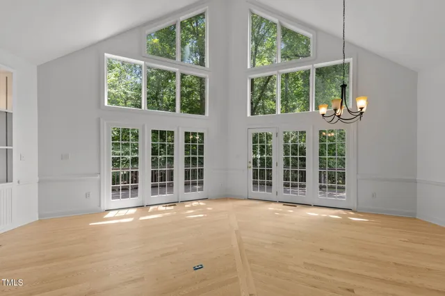 a view of an empty room with a window and balcony