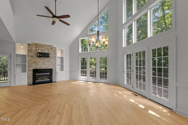 a view of an empty room with a fireplace and a window