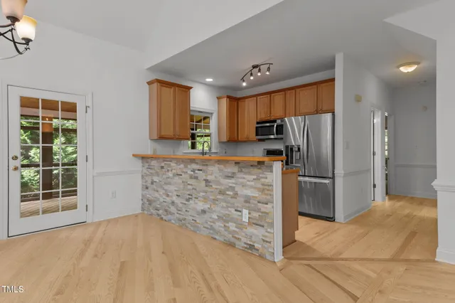 a kitchen with stainless steel appliances a refrigerator and a stove