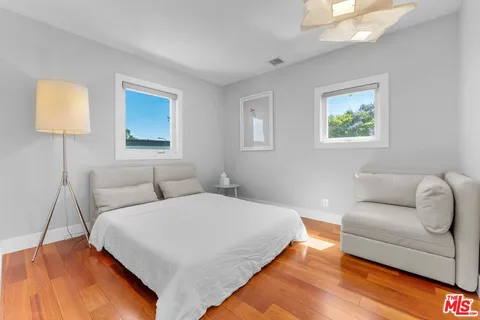 a bedroom with furniture and a window