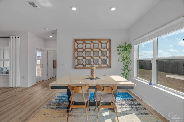 a view of a dining room with furniture window and wooden floor