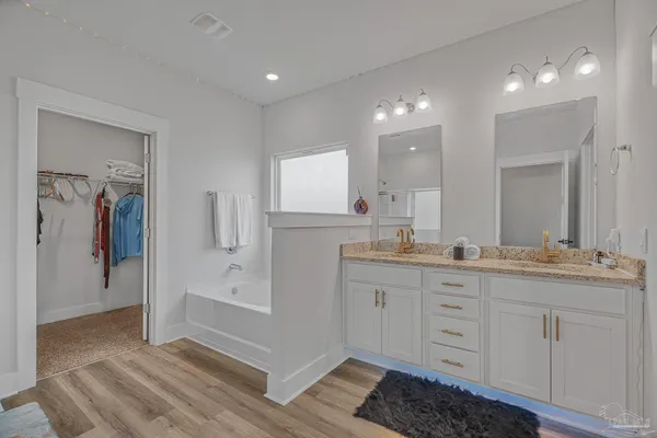 a bathroom with a double vanity sink and mirror