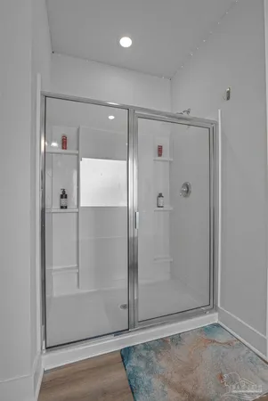 a bathroom with a glass shower door