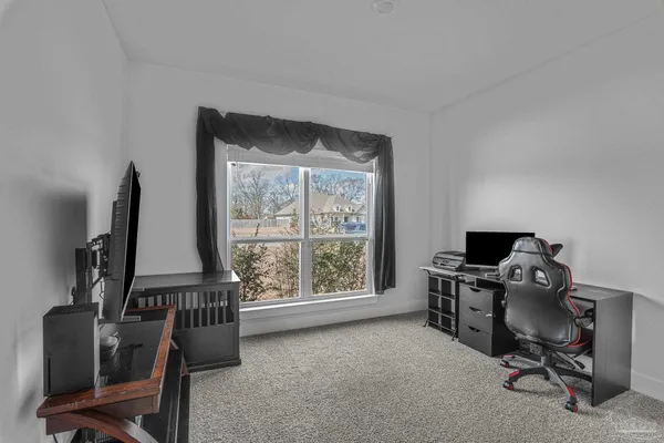 a view of a workspace with furniture and a window
