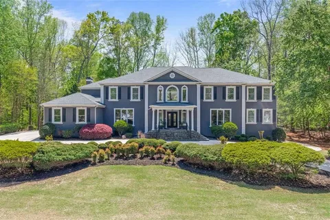 a front view of a house with a yard table and chairs