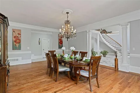 a living room with furniture windows and a wooden floor