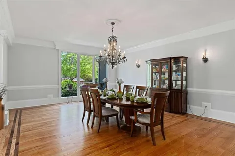 a kitchen with stainless steel appliances granite countertop a refrigerator a stove top oven a sink dishwasher a refrigerator and white cabinets with wooden floor