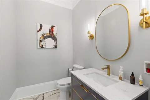 a kitchen with stainless steel appliances kitchen island granite countertop a stove a refrigerator a oven a sink with island chairs and wooden floor