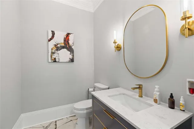 a kitchen with stainless steel appliances kitchen island granite countertop a stove a refrigerator a oven a sink with island chairs and wooden floor