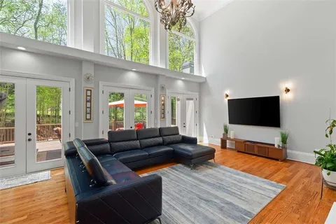 a kitchen with stainless steel appliances granite countertop a sink stove and wooden floor