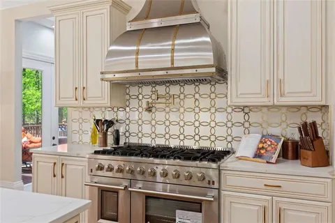 a living room with furniture a chandelier and a table
