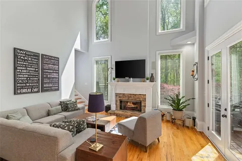 a living room with furniture a fireplace and a flat screen tv