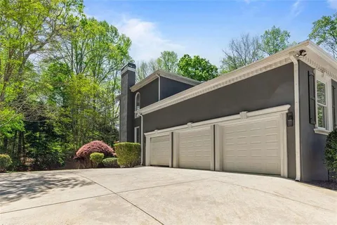 a view of a brick house with large windows